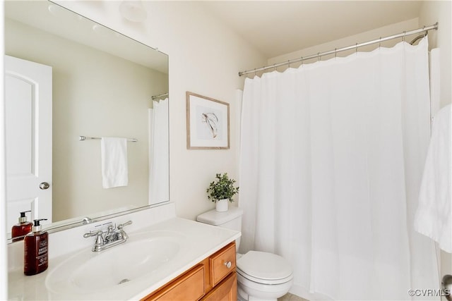 bathroom featuring toilet and vanity