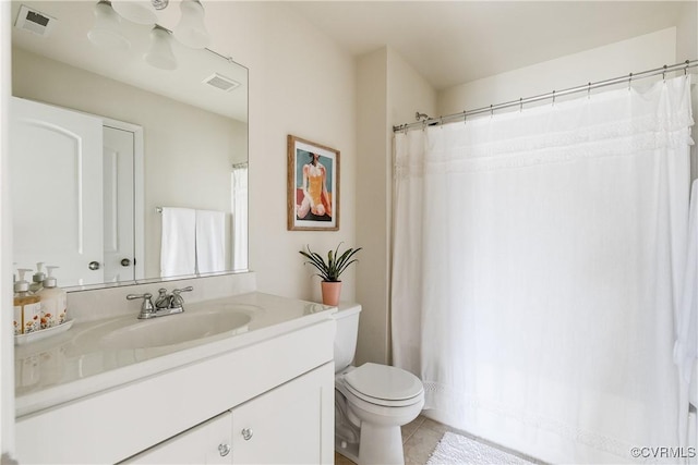 bathroom with tile patterned flooring, visible vents, vanity, and toilet