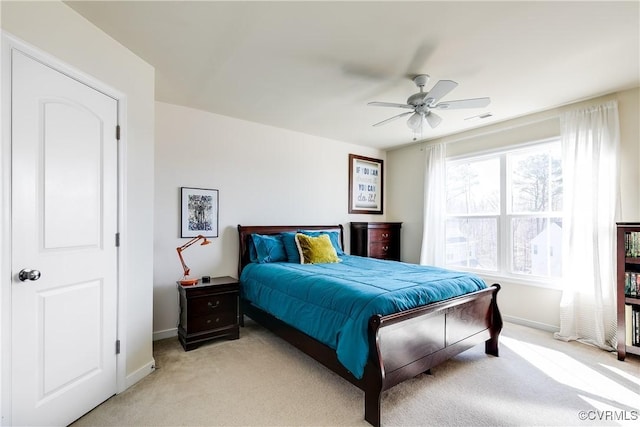 bedroom featuring baseboards, a ceiling fan, visible vents, and light colored carpet