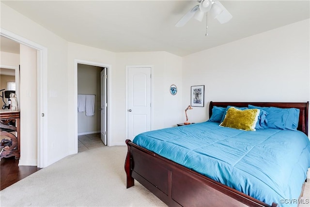 carpeted bedroom with ceiling fan and baseboards