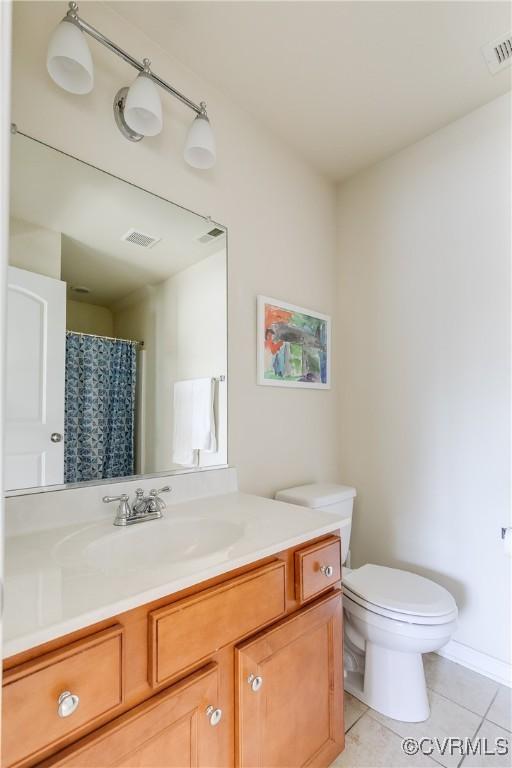 bathroom with toilet, tile patterned flooring, visible vents, and vanity