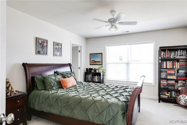 bedroom featuring light carpet, ceiling fan, visible vents, and baseboards