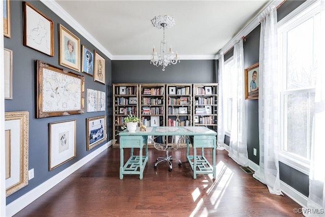 office space with ornamental molding, a notable chandelier, baseboards, and wood finished floors