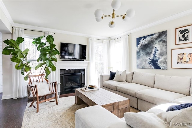 living room with ornamental molding, baseboards, dark wood finished floors, and a fireplace with flush hearth