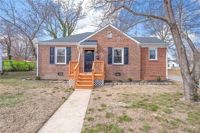 bungalow-style home featuring crawl space, a shingled roof, and brick siding