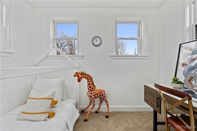 carpeted bedroom featuring baseboards