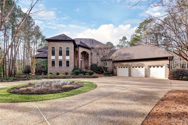 view of front facade with concrete driveway and brick siding