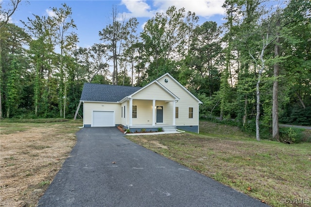 view of front of property featuring aphalt driveway, a garage, covered porch, roof with shingles, and a front lawn