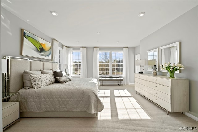 bedroom with recessed lighting, light carpet, and baseboards