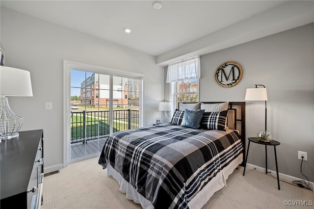 bedroom featuring light carpet, access to outside, visible vents, and baseboards