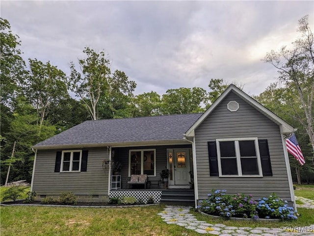 ranch-style house with a porch, a front yard, roof with shingles, and crawl space