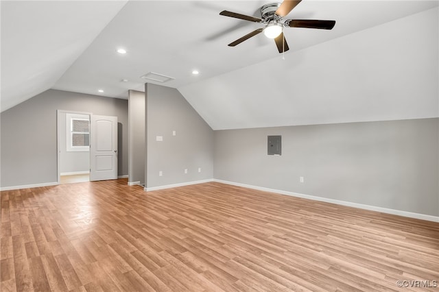 additional living space featuring light wood-style floors, electric panel, and baseboards