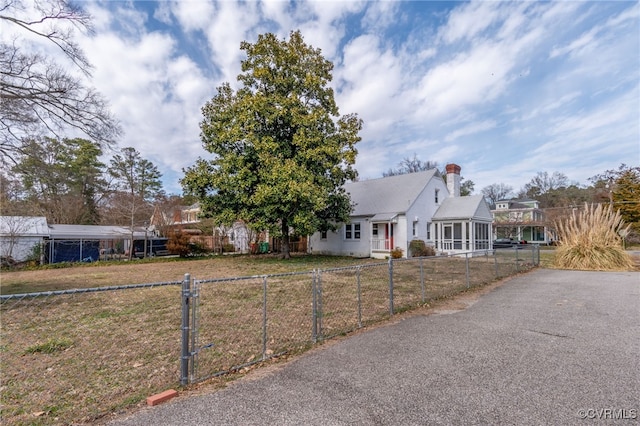 view of front of house featuring a fenced front yard, a chimney, and a front yard