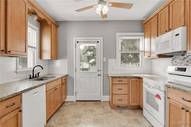 kitchen with tasteful backsplash, a ceiling fan, a sink, white appliances, and baseboards