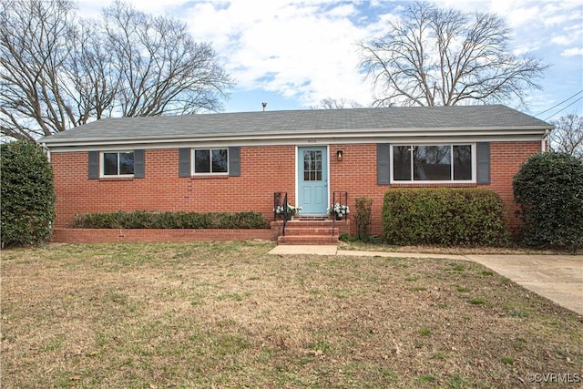 single story home with a front yard and brick siding