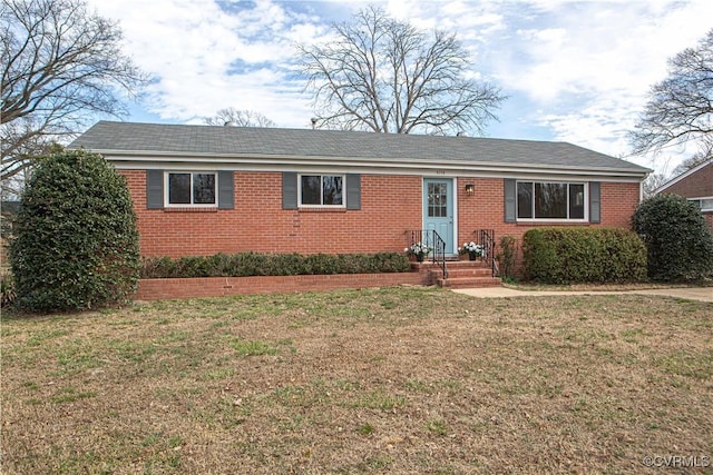 ranch-style house featuring a front yard and brick siding