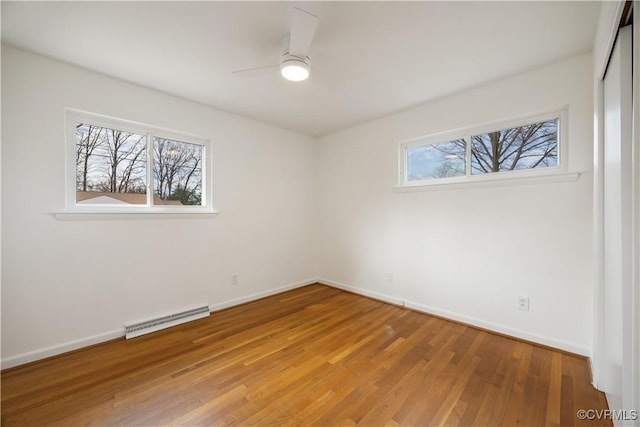 unfurnished bedroom featuring light wood-style flooring, a closet, multiple windows, and visible vents