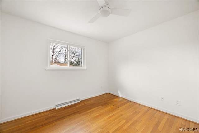 spare room with light wood-style flooring, a ceiling fan, visible vents, and baseboards