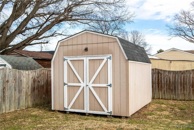 view of shed with a fenced backyard