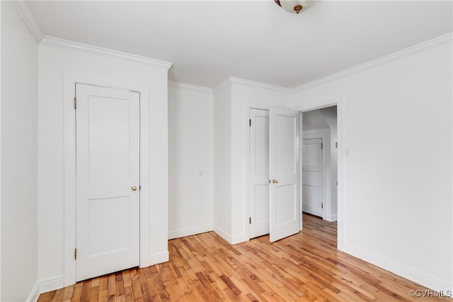 unfurnished bedroom with baseboards, light wood finished floors, and crown molding