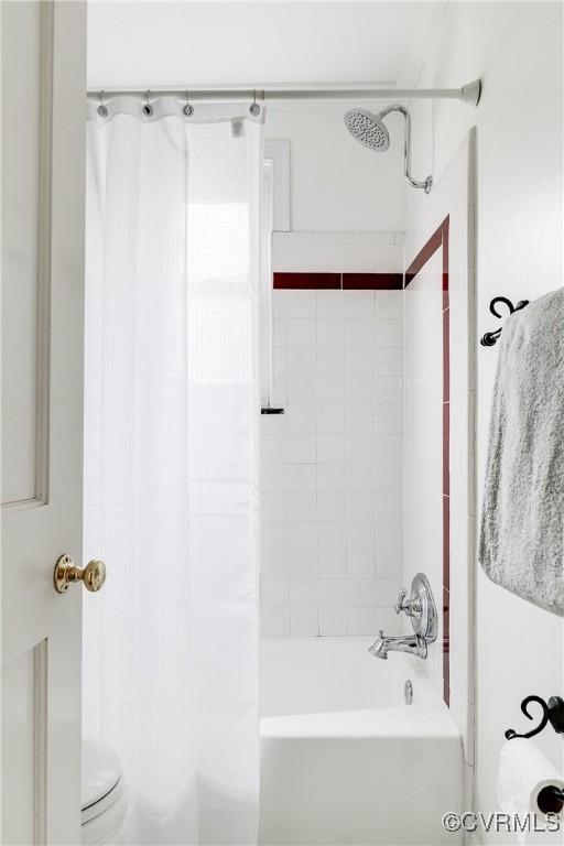 full bath featuring shower / bath combo with shower curtain and toilet