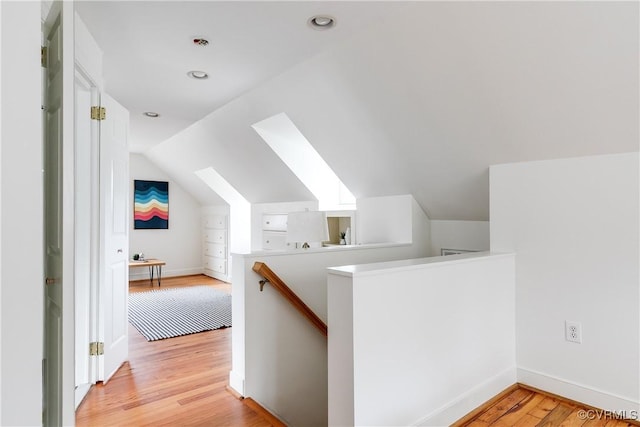 bonus room with light wood finished floors, baseboards, vaulted ceiling, and recessed lighting