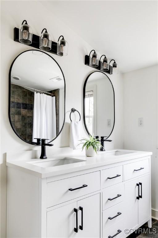 bathroom featuring double vanity and a sink