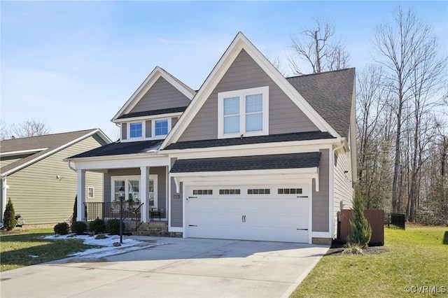 view of front of property with roof with shingles, a porch, concrete driveway, an attached garage, and a front yard