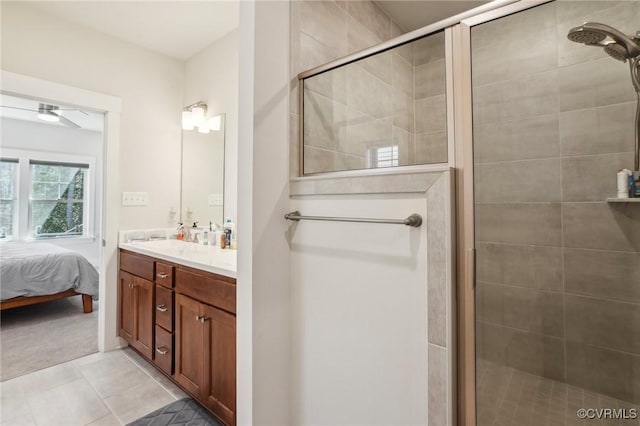 ensuite bathroom with a stall shower, ensuite bath, ceiling fan, tile patterned flooring, and vanity