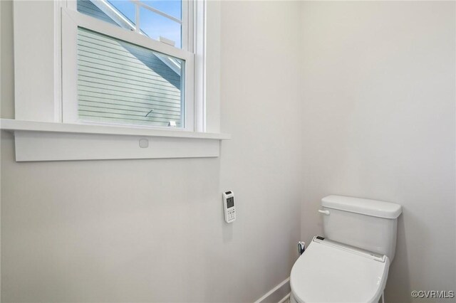 bathroom featuring toilet and a healthy amount of sunlight