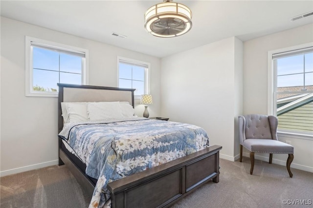 bedroom featuring carpet floors, visible vents, and baseboards