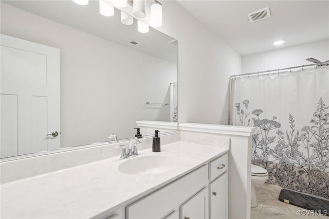 bathroom featuring toilet, marble finish floor, visible vents, and vanity