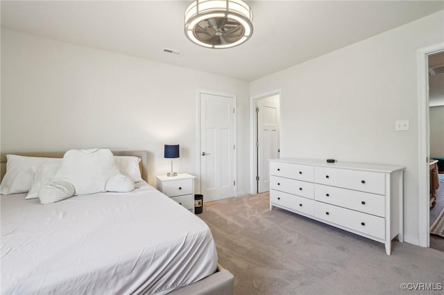 bedroom featuring light colored carpet and visible vents