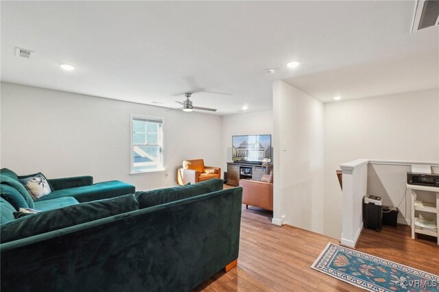 living room with a ceiling fan, light wood-type flooring, visible vents, and recessed lighting