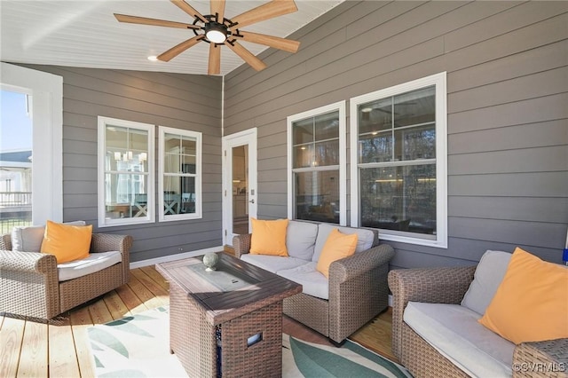 wooden deck with ceiling fan and an outdoor living space