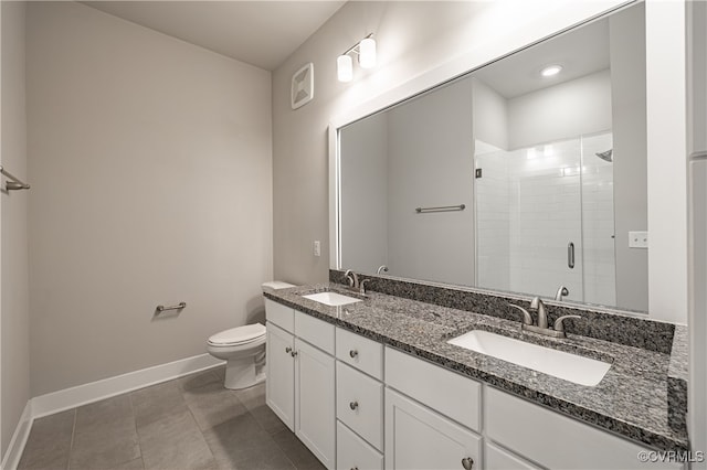 bathroom with a stall shower, a sink, toilet, and baseboards