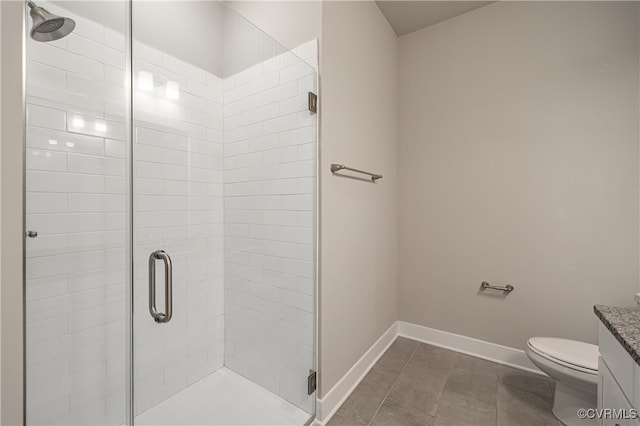 bathroom featuring a shower stall, baseboards, and vanity