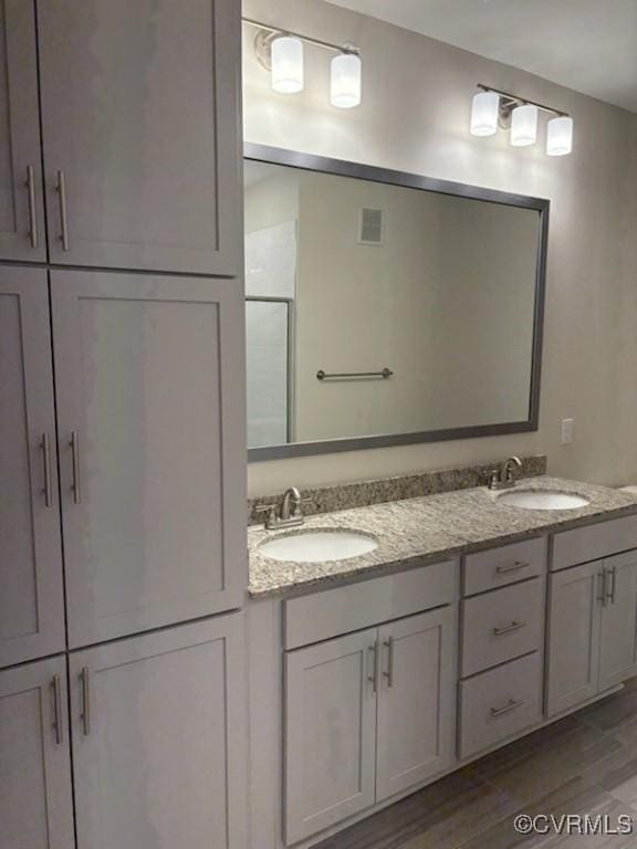 10530 Stony Bluff Dr Unit 304, Ashland, VA 23005 - full bathroom with double vanity, an enclosed shower, visible vents, and a sink