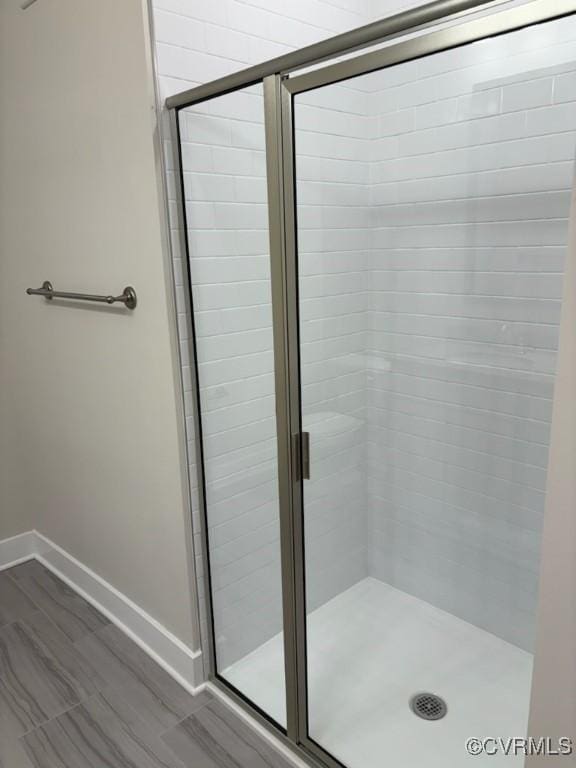 10530 Stony Bluff Dr Unit 304, Ashland, VA 23005 - full bathroom featuring baseboards and a shower stall