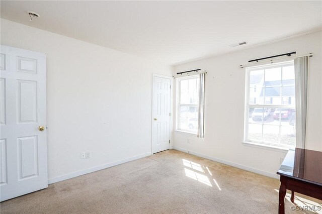 unfurnished bedroom featuring carpet floors, visible vents, and baseboards