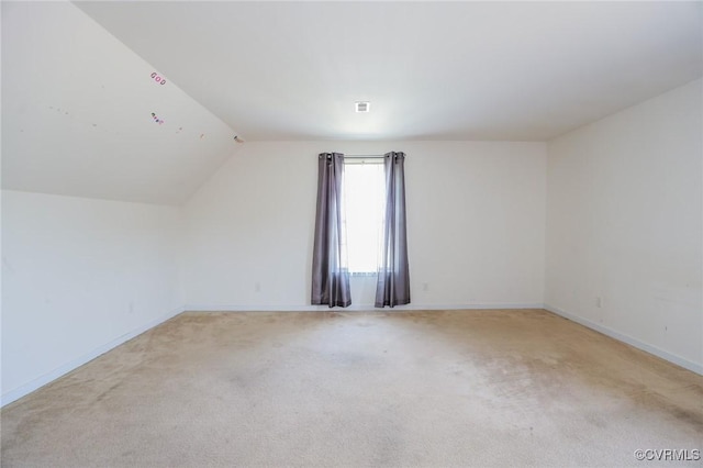 bonus room featuring light carpet, vaulted ceiling, and baseboards