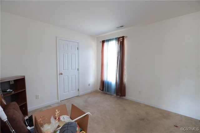 interior space featuring carpet floors, visible vents, and baseboards