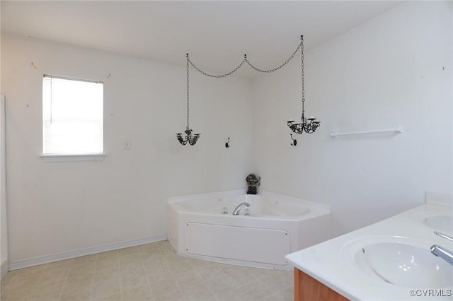 full bathroom featuring double vanity, a sink, a bath, baseboards, and tile patterned floors