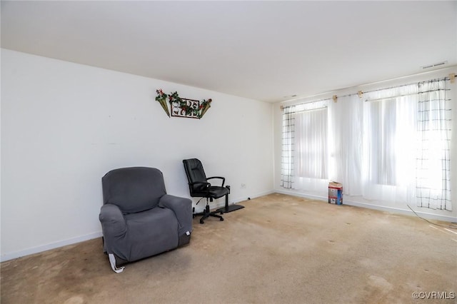 living area with carpet flooring, visible vents, and baseboards