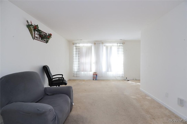 living area with carpet flooring and baseboards