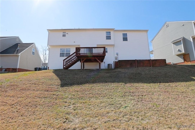 rear view of house with stairs, a lawn, and a wooden deck