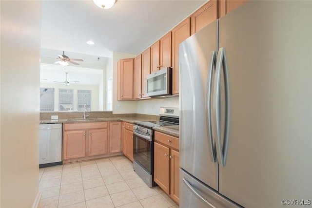 kitchen with stainless steel appliances, recessed lighting, a ceiling fan, light tile patterned flooring, and a sink