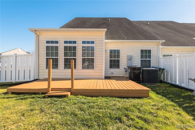 rear view of property with a deck, central air condition unit, fence, a yard, and roof with shingles