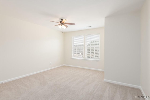 empty room with light carpet, baseboards, and a ceiling fan