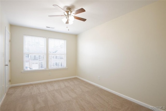 unfurnished room with light carpet, a ceiling fan, visible vents, and baseboards